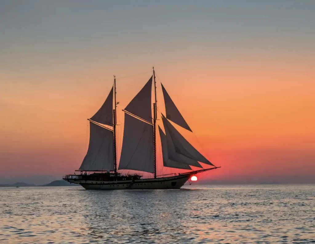 Lamima luxury yacht sailing at sunset in Komodo National Park