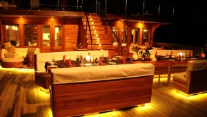 Evening alfresco dining setup on a luxury phinisi yacht