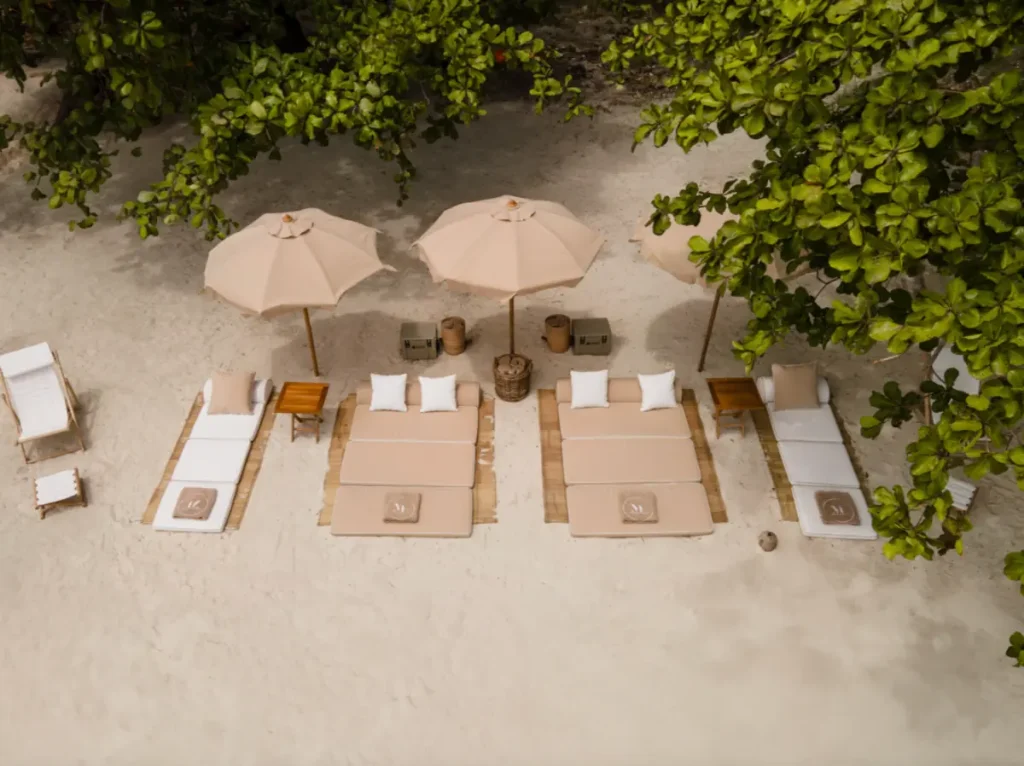 Elegant beach setup with umbrellas and loungers in Komodo