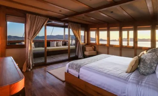 Master suite aboard a luxury phinisi yacht with ocean views