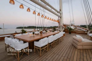 Elegant dining area on a phinisi yacht at sunset