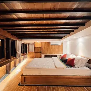 Spacious master cabin with wooden interior on a phinisi yacht
