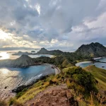 Aerial view of Padar Island at sunrise, showcasing its unique crescent beaches and rugged hills