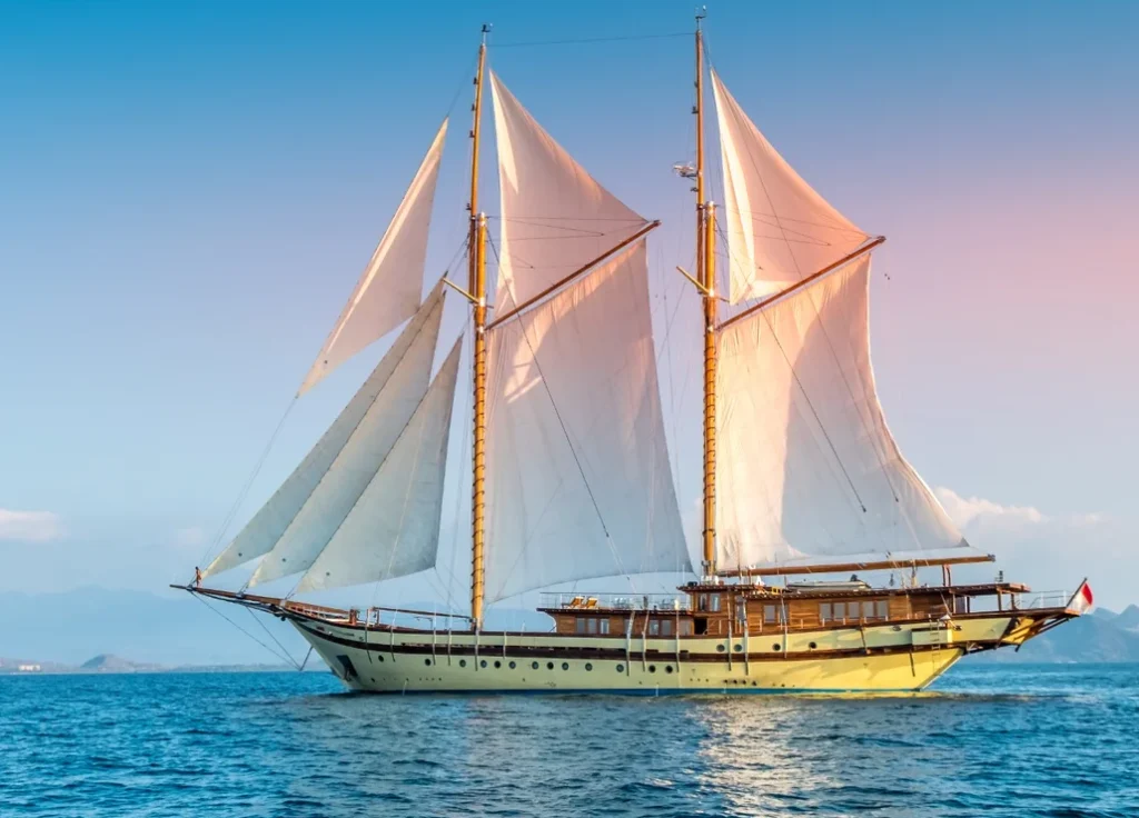 Lamima Luxury Yacht at sunset in Komodo National Park.